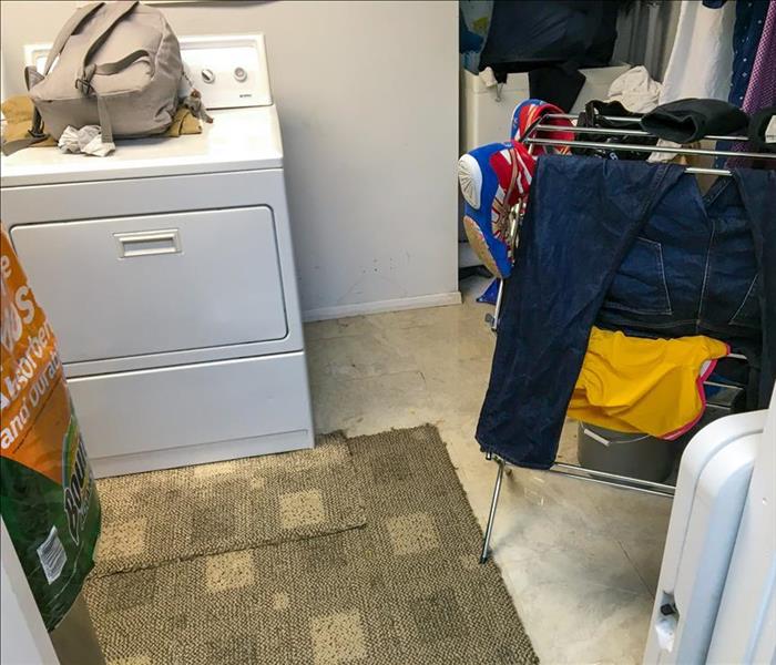 utility room, dryer and clothing on a room